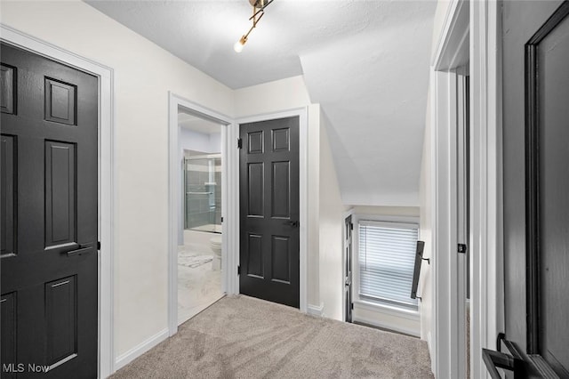 corridor featuring carpet floors and baseboards