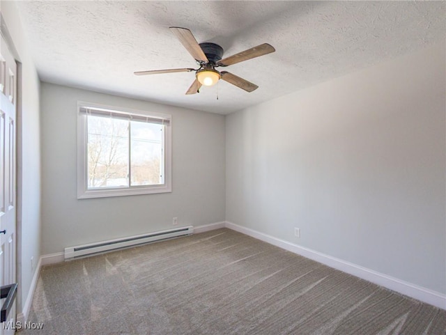 empty room with a baseboard heating unit, a ceiling fan, carpet flooring, a textured ceiling, and baseboards