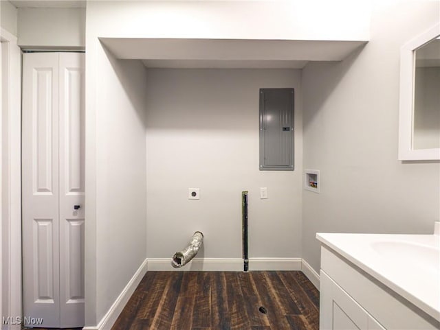 washroom with dark wood-style flooring, hookup for a washing machine, hookup for an electric dryer, electric panel, and baseboards