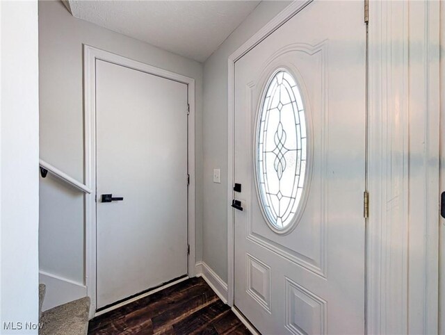 foyer entrance with dark wood finished floors