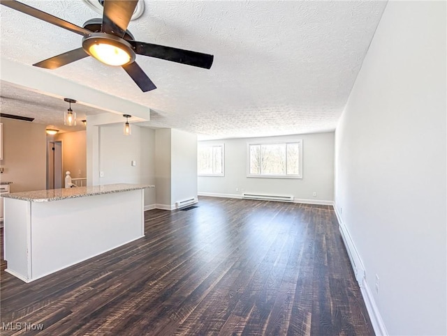 unfurnished living room with dark wood-style floors, baseboard heating, a ceiling fan, a textured ceiling, and baseboards