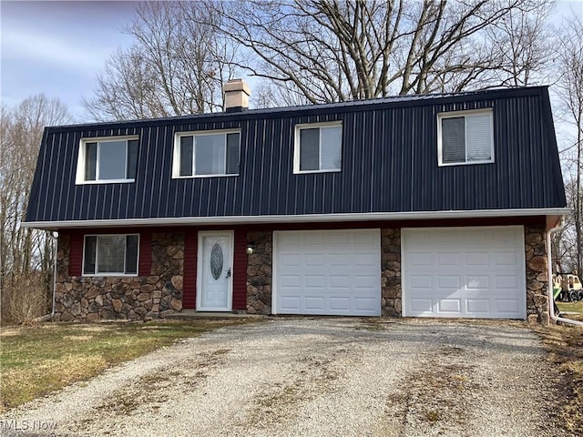 view of front of property featuring aphalt driveway, a chimney, an attached garage, metal roof, and stone siding