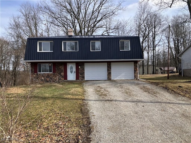 view of front of house with aphalt driveway, a chimney, an attached garage, stone siding, and a front lawn