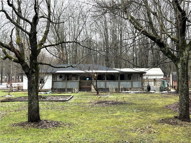 ranch-style house with covered porch and a front lawn