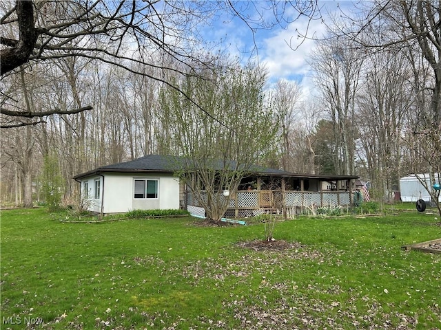 5123 4th Ave, Andover, OH 44003 - view of front of home featuring stucco siding and a front lawn