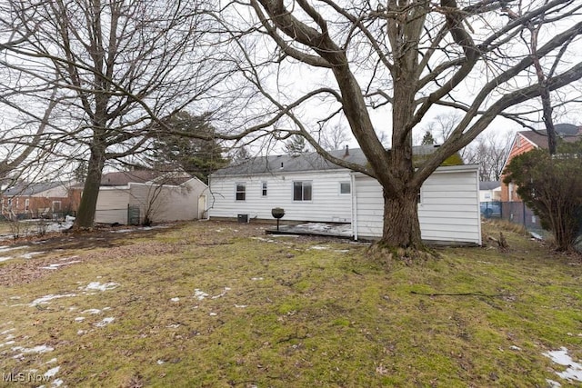 rear view of house featuring fence