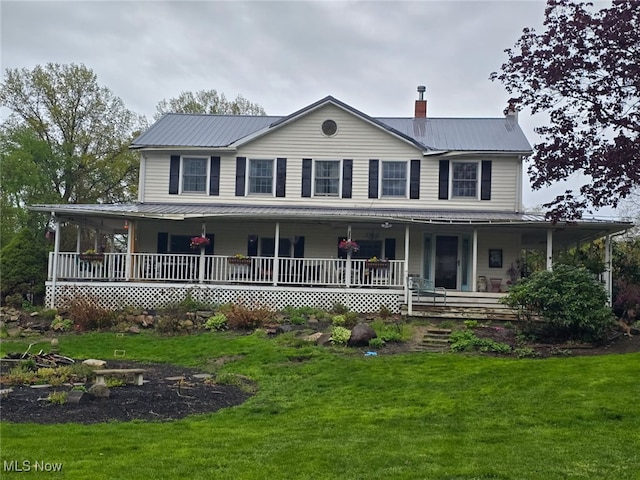 5261 E Maple Rd, Geneva, OH 44041 - farmhouse-style home featuring a front lawn, covered porch, a chimney, and metal roof