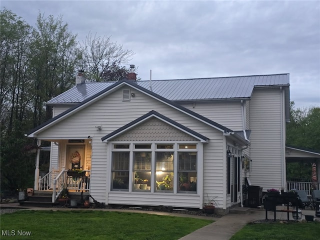5261 E Maple Rd, Geneva, OH 44041 - rear view of property featuring a yard, metal roof, and a chimney