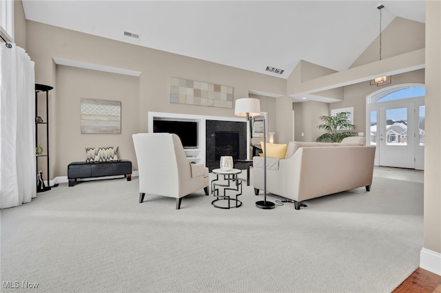7571 Silverleaf Ct, Sagamore Hills, OH 44067 - carpeted living room featuring high vaulted ceiling and a chandelier