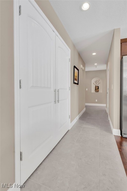 7571 Silverleaf Ct, Sagamore Hills, OH 44067 - hallway featuring recessed lighting and tile patterned floors