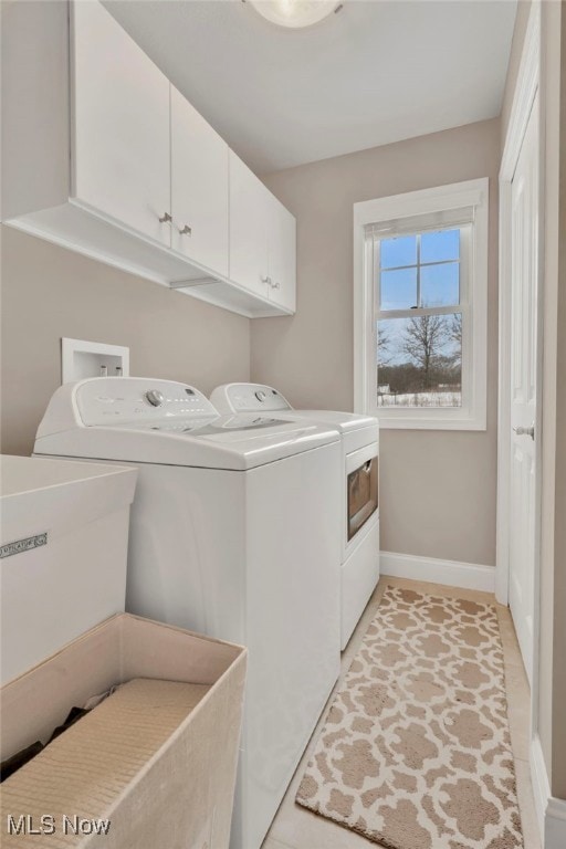 7571 Silverleaf Ct, Sagamore Hills, OH 44067 - laundry area with washer and dryer, cabinet space, and light tile patterned flooring