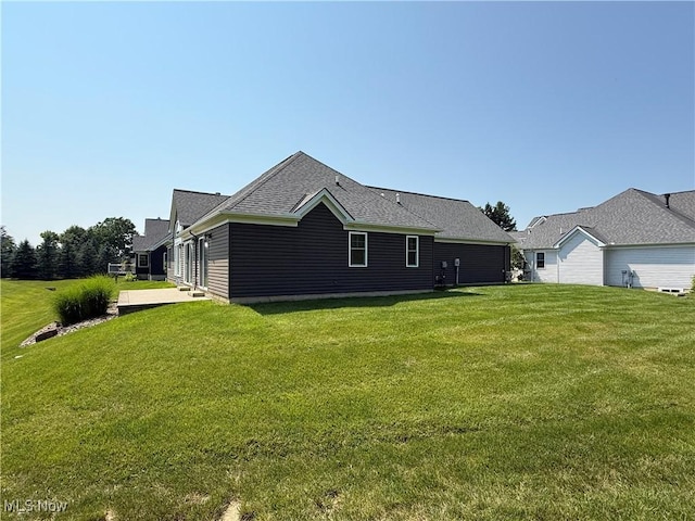 7571 Silverleaf Ct, Sagamore Hills, OH 44067 - rear view of house with a lawn and roof with shingles