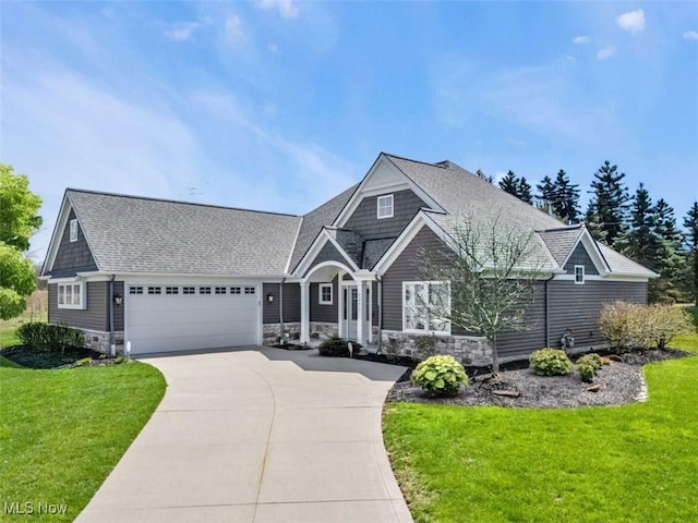 7571 Silverleaf Ct, Sagamore Hills, OH 44067 - view of front of property featuring stone siding, an attached garage, concrete driveway, and a front yard