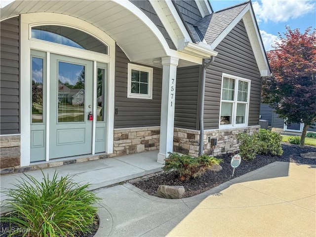 7571 Silverleaf Ct, Sagamore Hills, OH 44067 - doorway to property featuring covered porch and stone siding