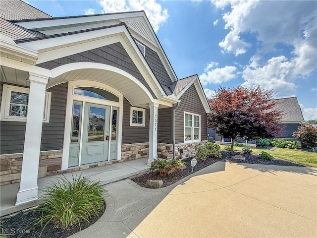 7571 Silverleaf Ct, Sagamore Hills, OH 44067 - entrance to property with stone siding and covered porch