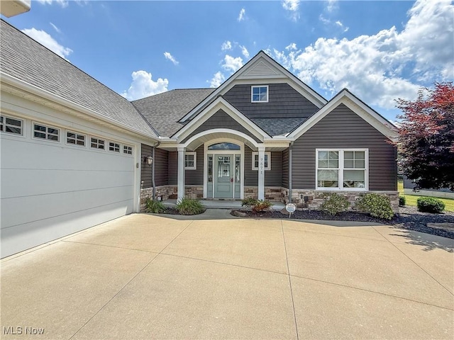7571 Silverleaf Ct, Sagamore Hills, OH 44067 - view of front of home with concrete driveway, roof with shingles, stone siding, and a garage