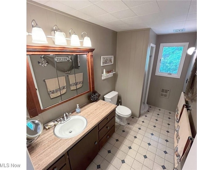 full bathroom with toilet, visible vents, a shower, and vanity