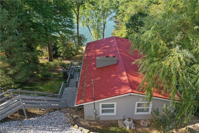 view of side of property featuring stairway and a deck