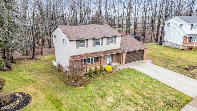 view of front of property with brick siding, roof with shingles, an attached garage, driveway, and a front lawn