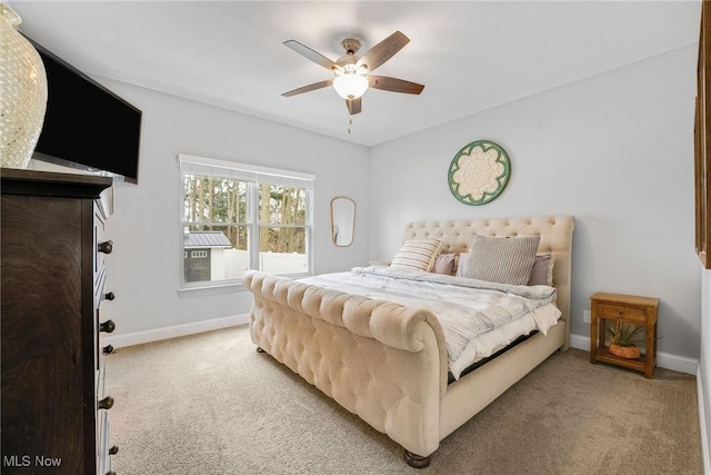 carpeted bedroom featuring a ceiling fan and baseboards