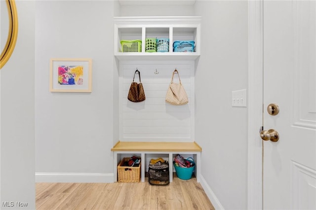 mudroom featuring wood finished floors and baseboards