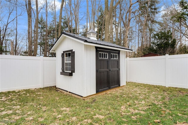 view of shed with a fenced backyard