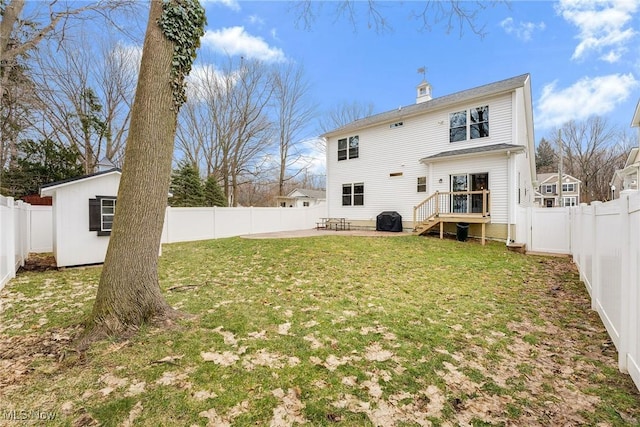 back of property with a patio area, a fenced backyard, and a lawn