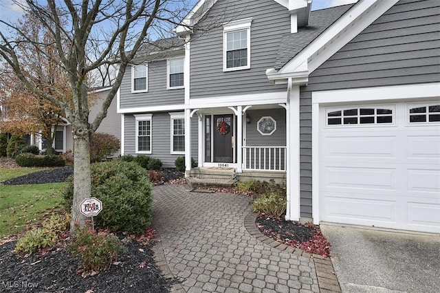 view of front of property featuring roof with shingles and an attached garage