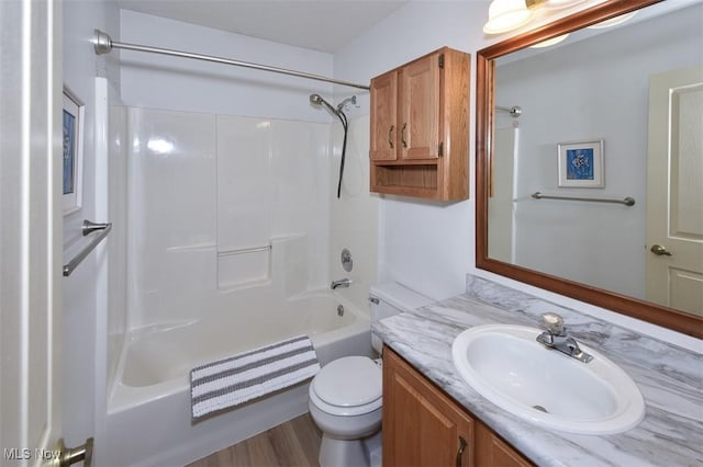 bathroom with toilet, shower / bathtub combination, and vanity