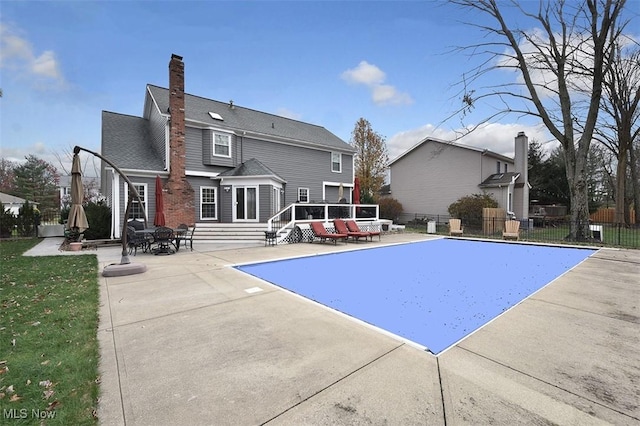 view of swimming pool with entry steps, a patio area, and fence