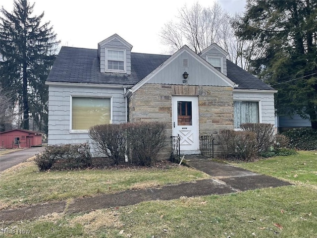 new england style home with stone siding and a front yard