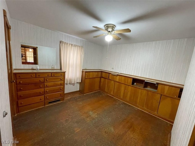 interior space with concrete flooring and a ceiling fan