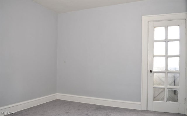 carpeted spare room with baseboards