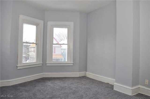 carpeted spare room with baseboards