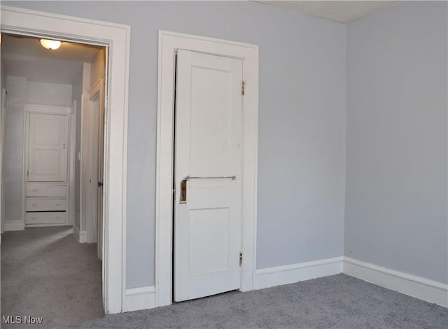 unfurnished bedroom with carpet and baseboards