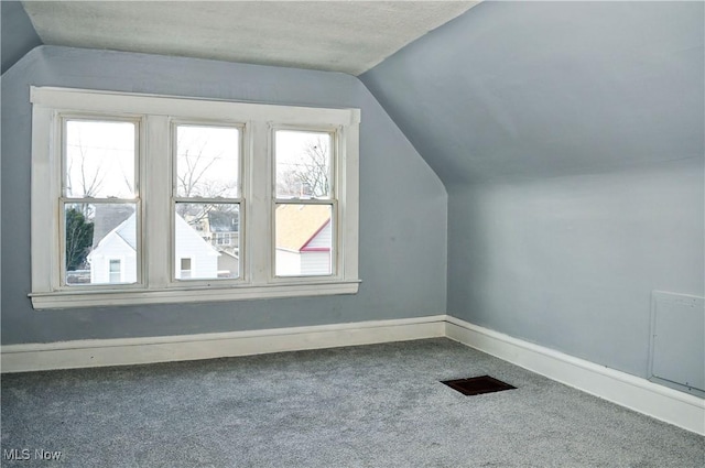 bonus room featuring lofted ceiling, baseboards, and carpet flooring