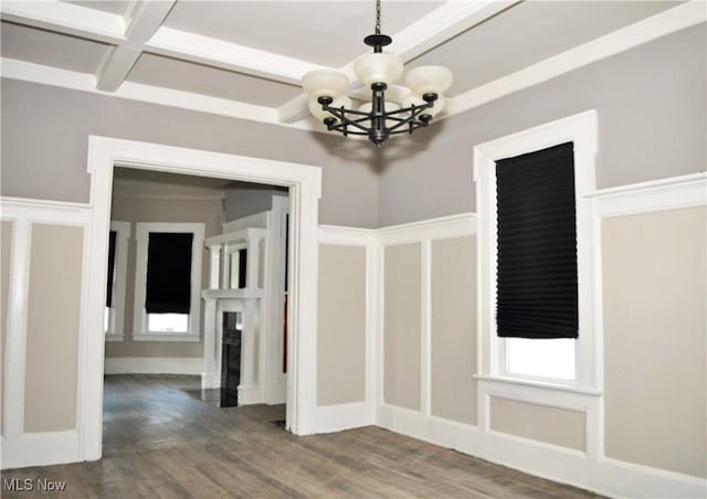 interior space featuring a chandelier, a fireplace, coffered ceiling, wood finished floors, and beamed ceiling