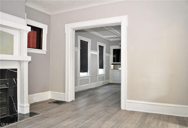 interior space featuring visible vents, baseboards, and wood finished floors