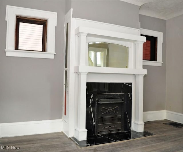 room details featuring visible vents, baseboards, and wood finished floors