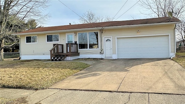 view of front facade featuring a front lawn, concrete driveway, fence, and an attached garage