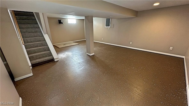 basement featuring baseboards and stairs