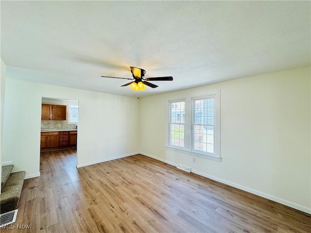 1019 Trenton, Toronto, OH 43964 - unfurnished living room with ceiling fan, light wood-style flooring, visible vents, and baseboards