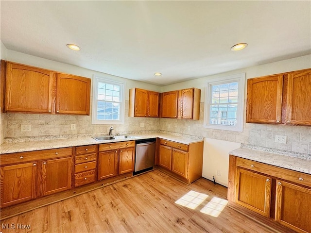1019 Trenton, Toronto, OH 43964 - kitchen featuring a wealth of natural light, brown cabinets, dishwasher, and a sink