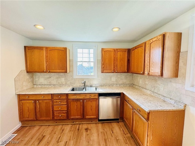 1019 Trenton, Toronto, OH 43964 - kitchen featuring a sink, brown cabinetry, dishwasher, and light countertops