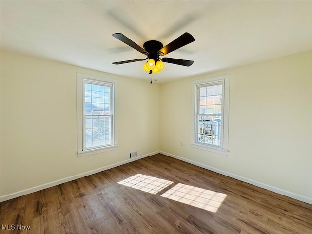 1019 Trenton, Toronto, OH 43964 - spare room with a healthy amount of sunlight, baseboards, and wood finished floors