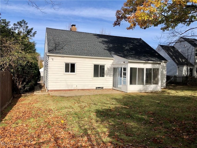 back of house with a shingled roof, a fenced backyard, a yard, and a chimney