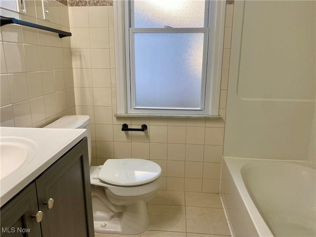 full bathroom featuring tile patterned flooring, toilet, tile walls, and vanity