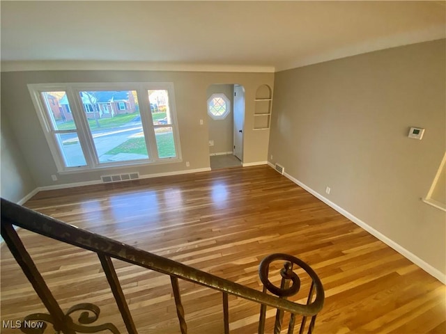 interior space featuring wood finished floors, visible vents, and baseboards