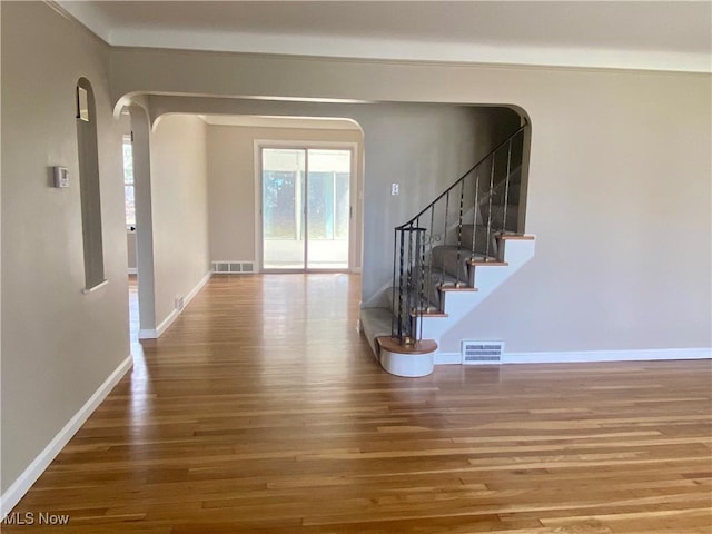 interior space featuring visible vents, baseboards, and wood finished floors