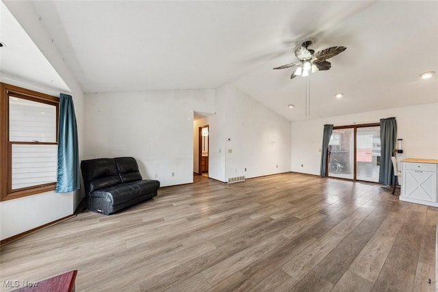 unfurnished living room featuring vaulted ceiling, wood finished floors, visible vents, and a ceiling fan